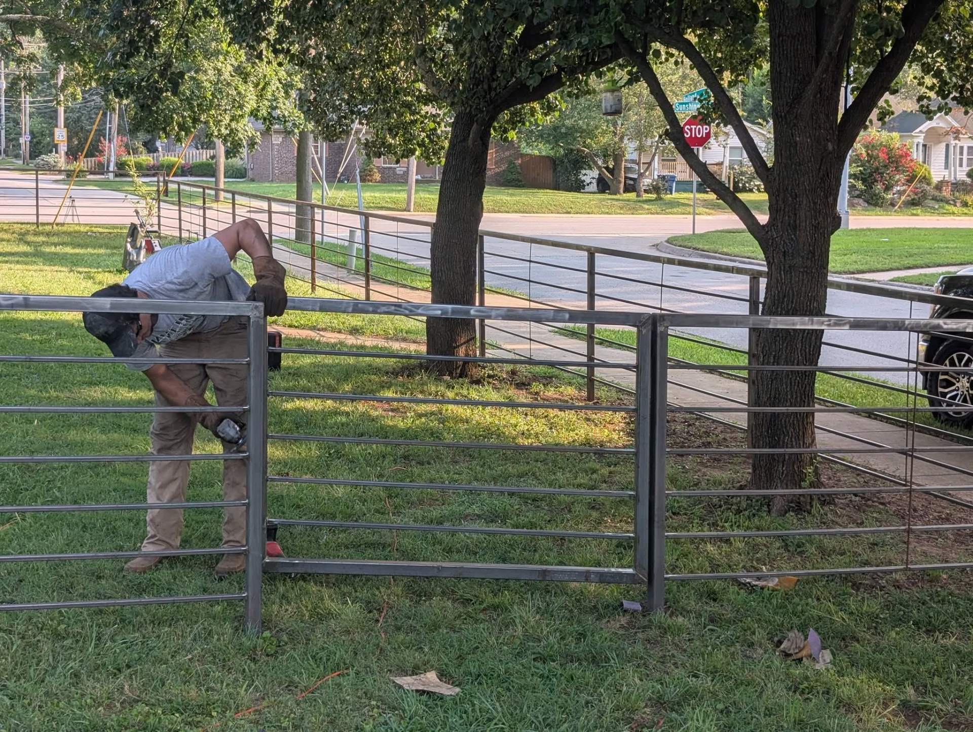 Worker assembling a horizontal rail fence